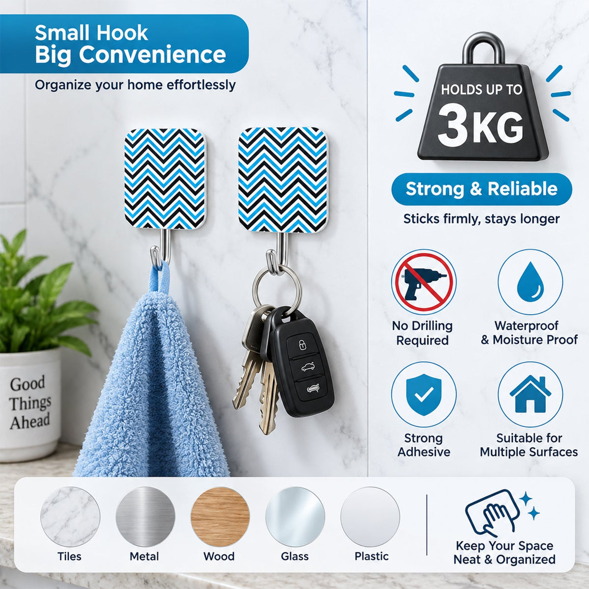 Two chevron-patterned adhesive hooks hold a light blue towel and a set of keys on a white tiled wall.
