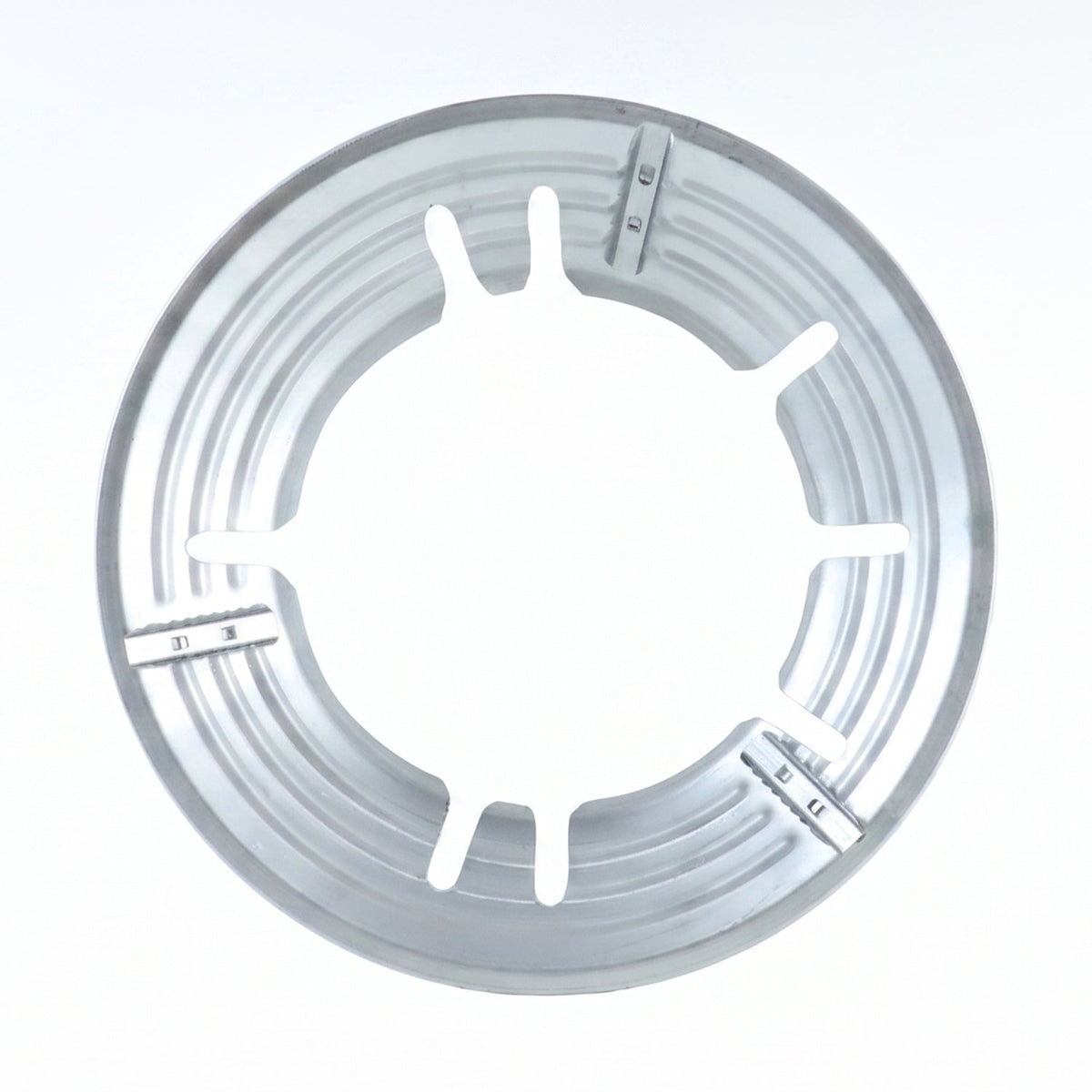 A top-down view of the circular silver gas stove trivet with six inner supports.