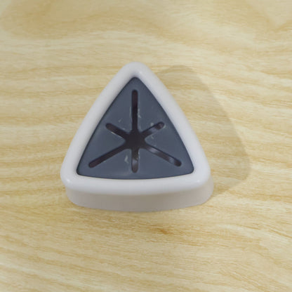 A white and grey triangular towel holder with a star-shaped opening is centered on a light wooden surface.