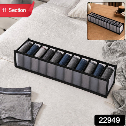 A gray 11-section fabric organizer with rolled socks on a white bedspread, with a red "11 Section" label and a black "22949"