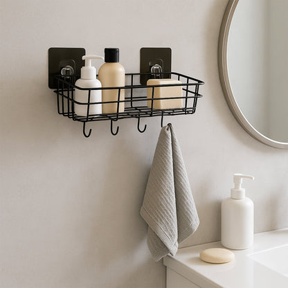 A single black metal wall-mounted storage basket with hooks, holding bath products and a grey towel hanging from a hook.