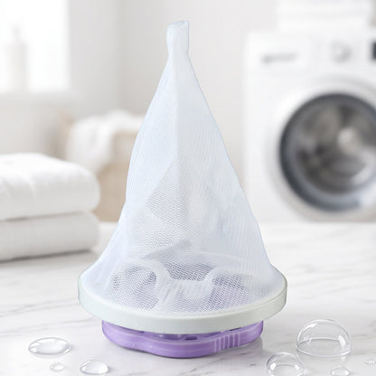 A purple and white floating lint mesh bag on a white counter with a washing machine in the background.