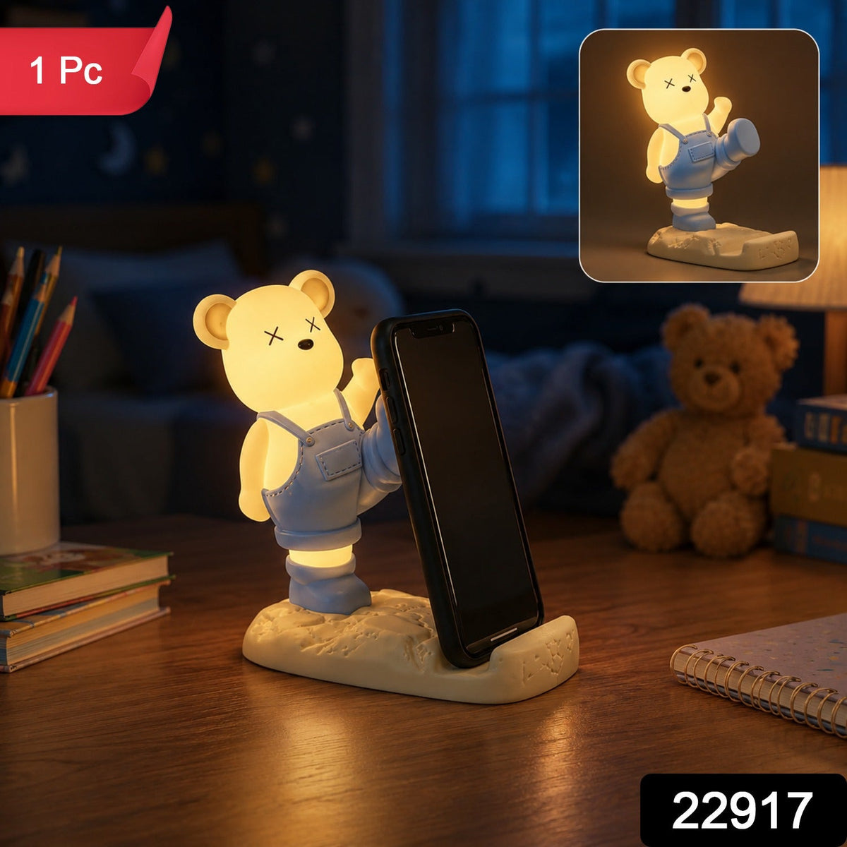 A glowing yellow bear phone holder with blue overalls on a desk at night, with a "1 Pc" label.