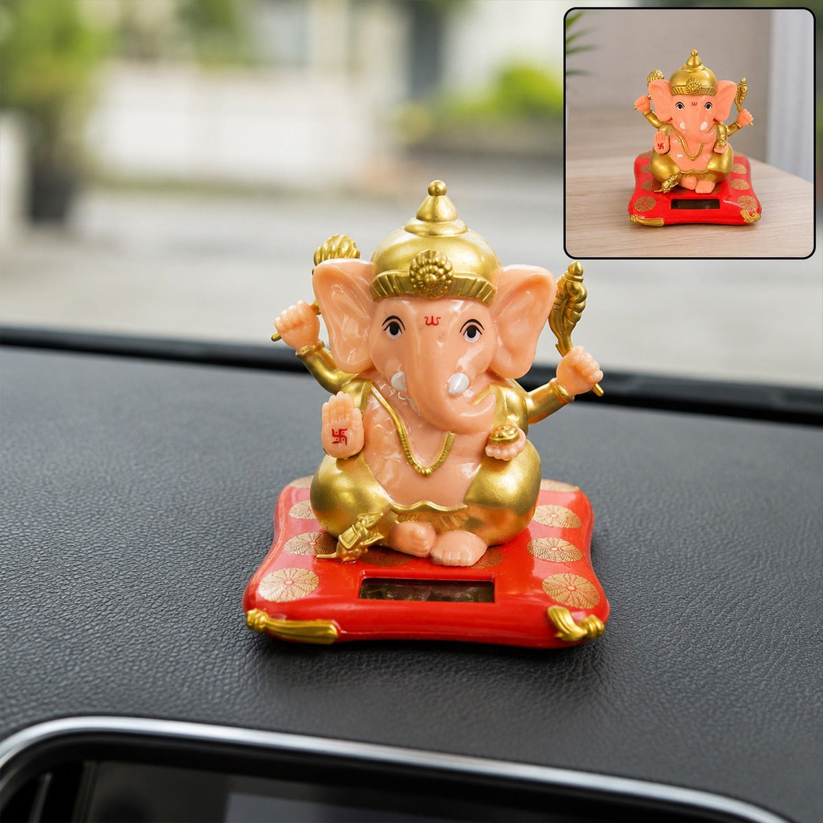 A small, peach and gold Ganesha idol on a red solar-powered base sits on a car dashboard.