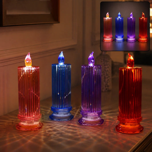 Four LED crystal candles in red, blue, purple, and orange, casting light patterns on a wooden surface.
