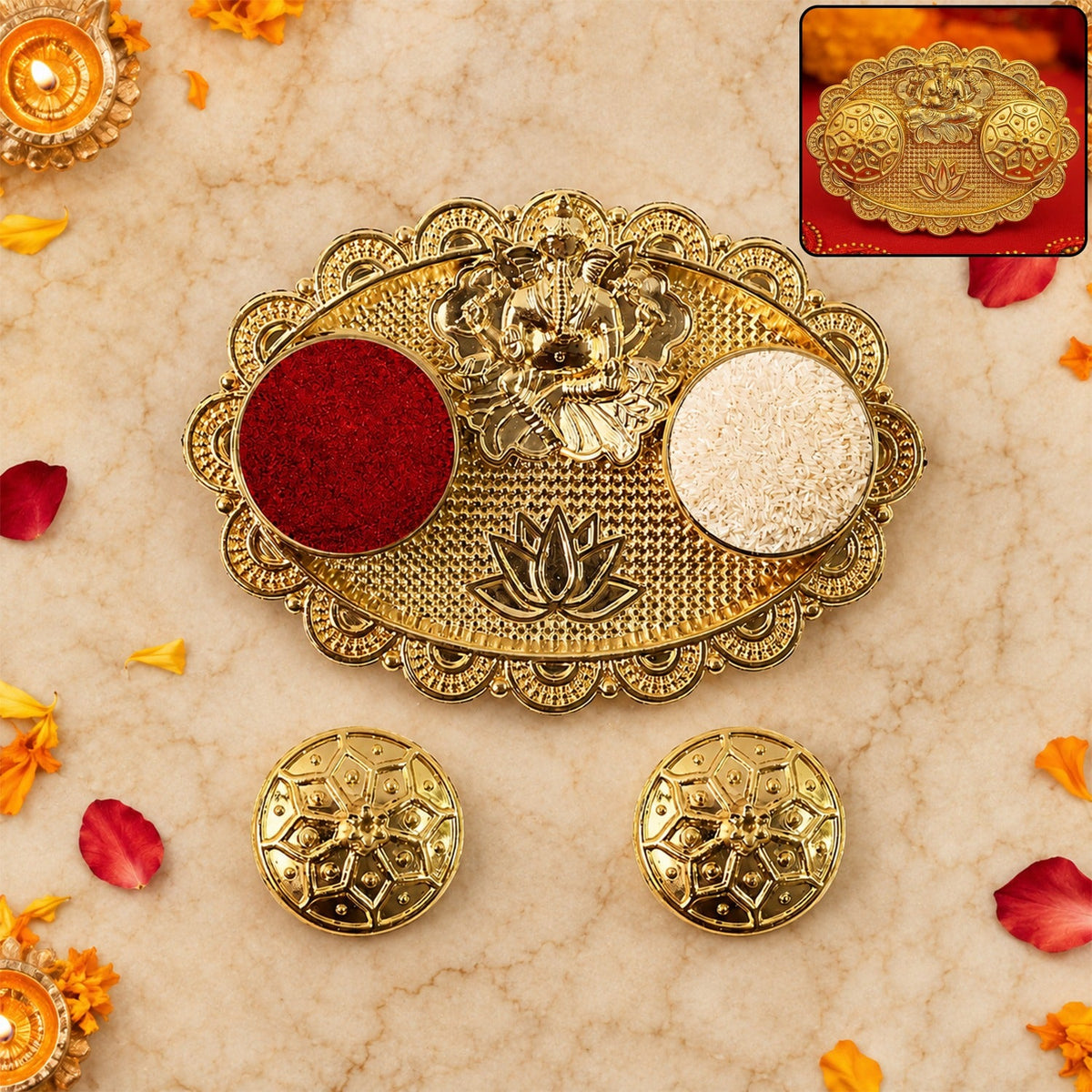 A gold-finished chopra with Ganesh, two round containers with red kumkum and white rice, and two small gold lids on a marble