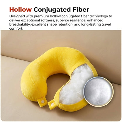 A yellow neck pillow is cut open to reveal its white, fluffy hollow conjugated fiber filling, on a beige sofa.