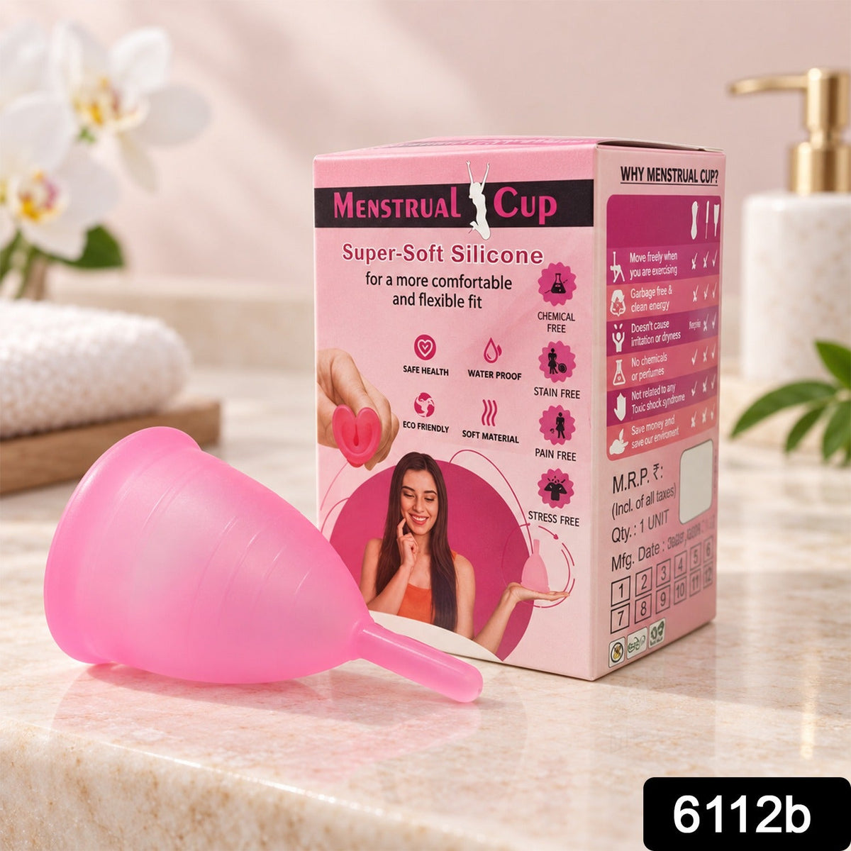 Two pink silicone menstrual cups are displayed on a white rectangular tray with a white flower and towel.