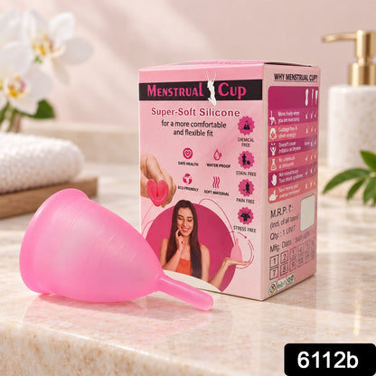 Two pink silicone menstrual cups are displayed on a white rectangular tray with a white flower and towel.