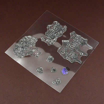 A clear rubber stamp sheet with various nature-themed designs is shown on a brown surface.