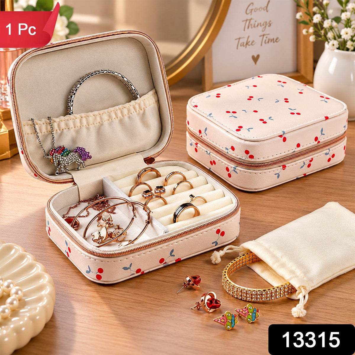 A cherry print jewelry organizer, open and closed, with various jewelry pieces and a small pouch on wood.