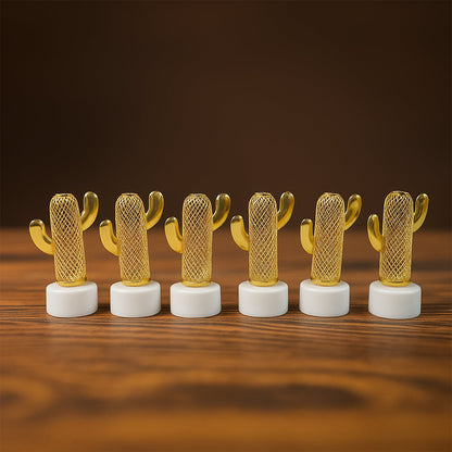 Six golden cactus-shaped LED lights with white bases, unlit, arranged in a line on a wooden surface.