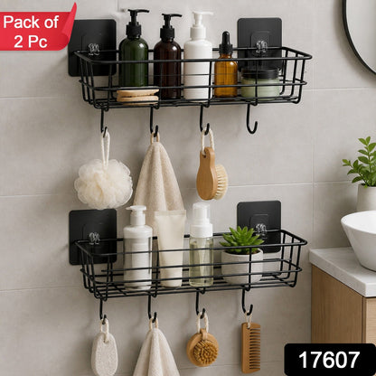 Two black metal wall-mounted storage baskets with hooks, filled with various bathroom products and hanging items, with a