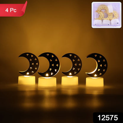Four crescent moon LED tea lights with warm yellow glow in a dark room, with a small box of four lights in the top right