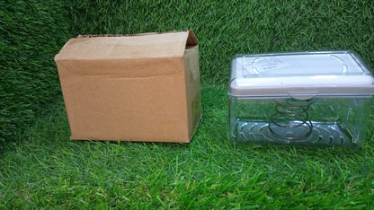 Clear plastic soap dispenser with rollers placed on kitchen countertop