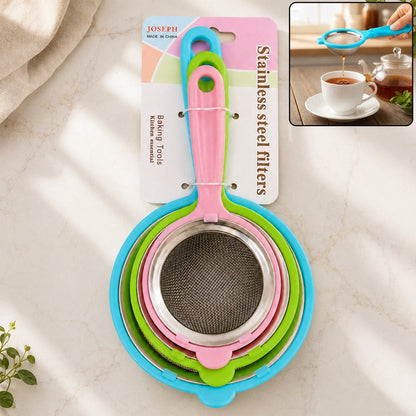 Three nested strainers with colorful plastic handles and stainless steel mesh, packaged together on a white countertop.