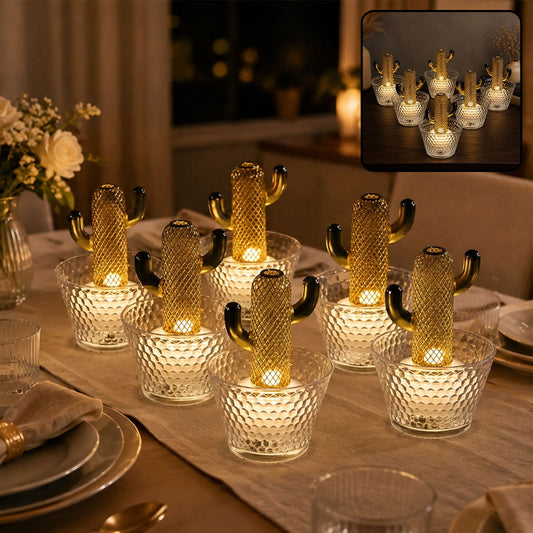 Six gold cactus LED lights in clear textured pots illuminate a dining table at night.