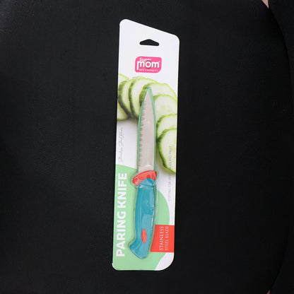 A paring knife with a blue and red handle and serrated blade is sealed in its retail packaging against a dark background.