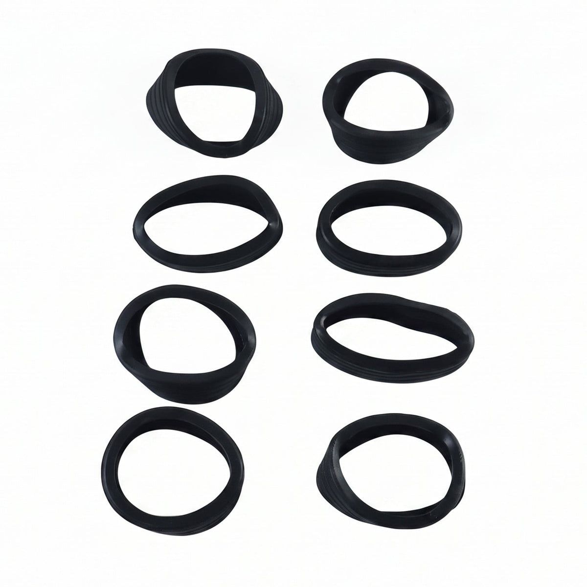 Eight black silicone rings, some slightly distorted, arranged in two vertical rows on a white background.