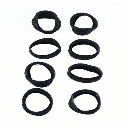Eight black silicone rings, some slightly distorted, arranged in two vertical rows on a white background.