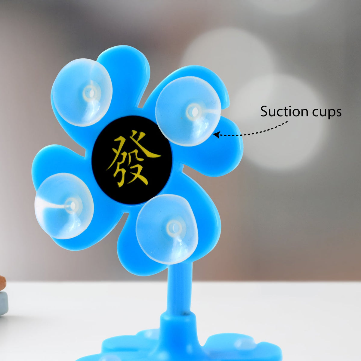 Close-up of a blue flower-shaped phone holder, highlighting the suction cups and Chinese character.
