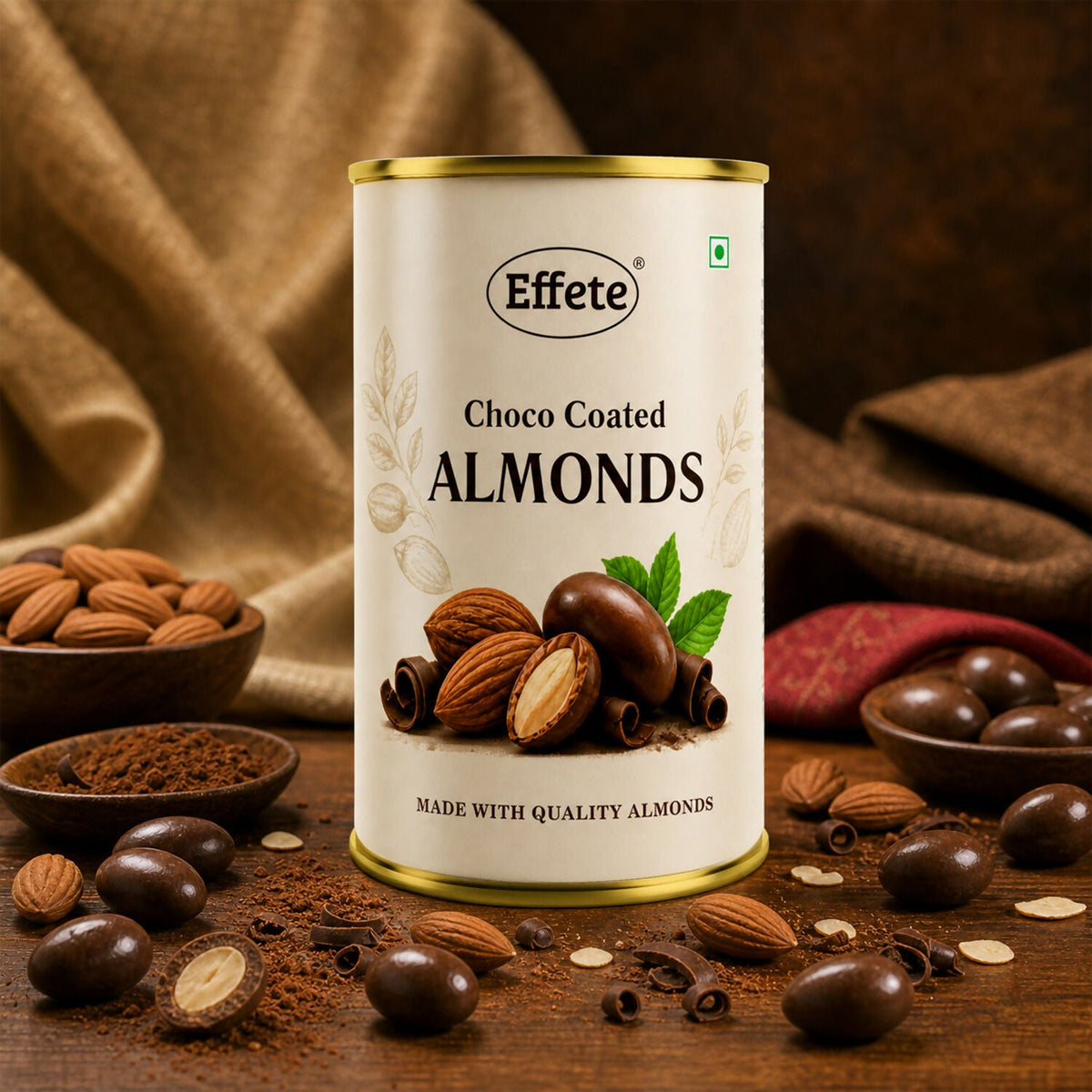 A tin of Effete Choco Coated Almonds on a wooden table with scattered almonds, cocoa powder, and chocolate-covered almonds.