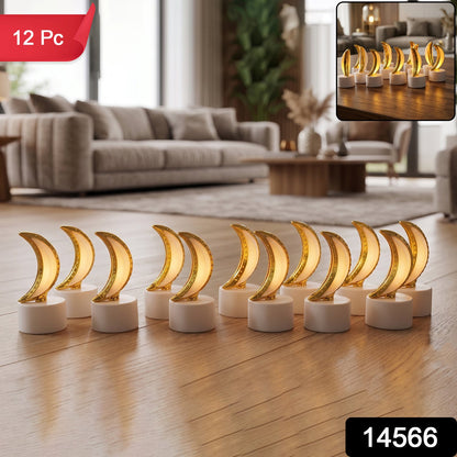 Twelve golden crescent moon LED tealights with warm glow on a wooden floor in living room.