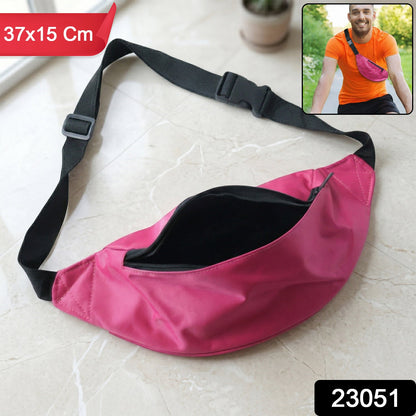 A bright pink fanny pack with a black strap and open zipper lies on a tiled surface.