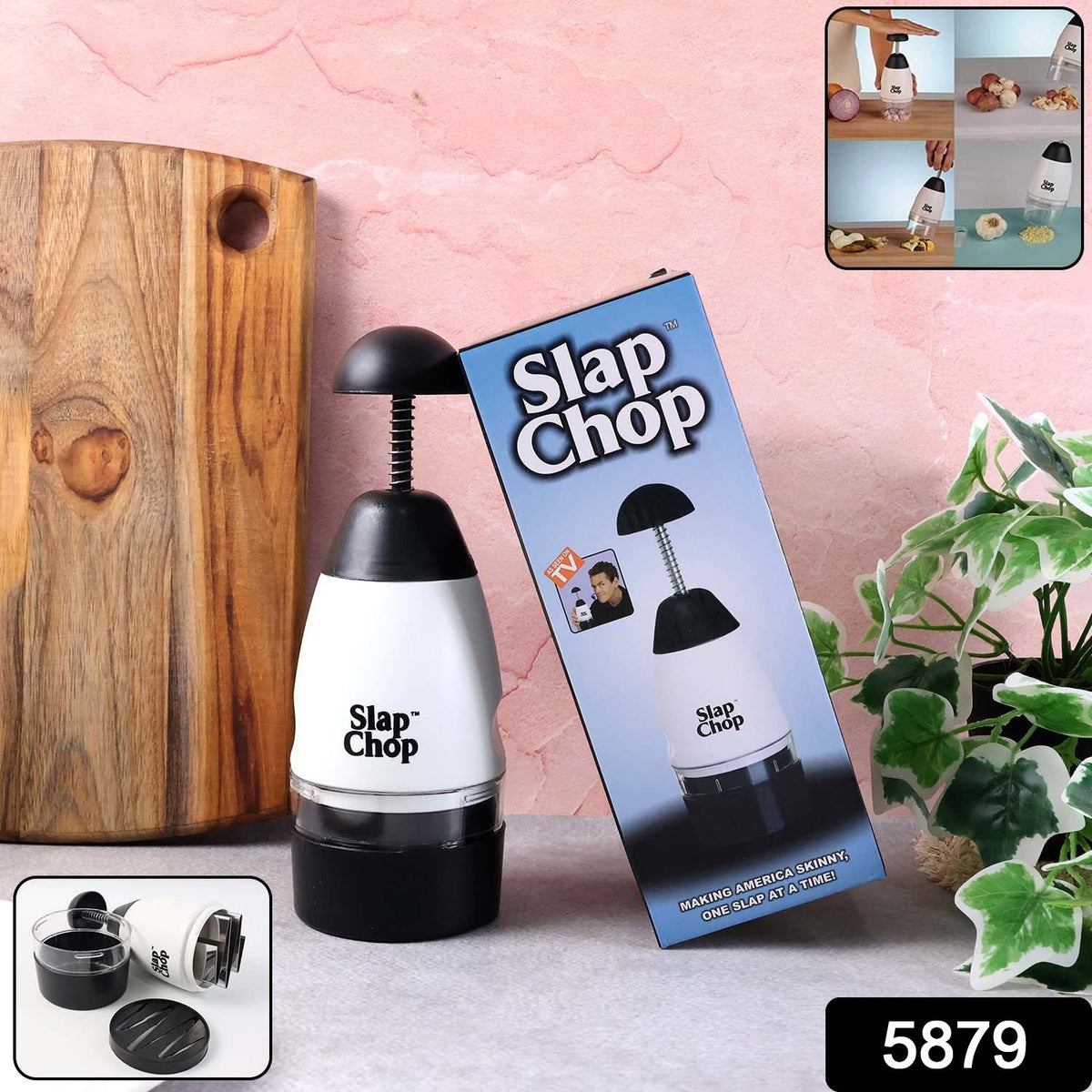 The white and black manual food chopper sits next to its blue retail packaging on a counter with a wooden cutting board.