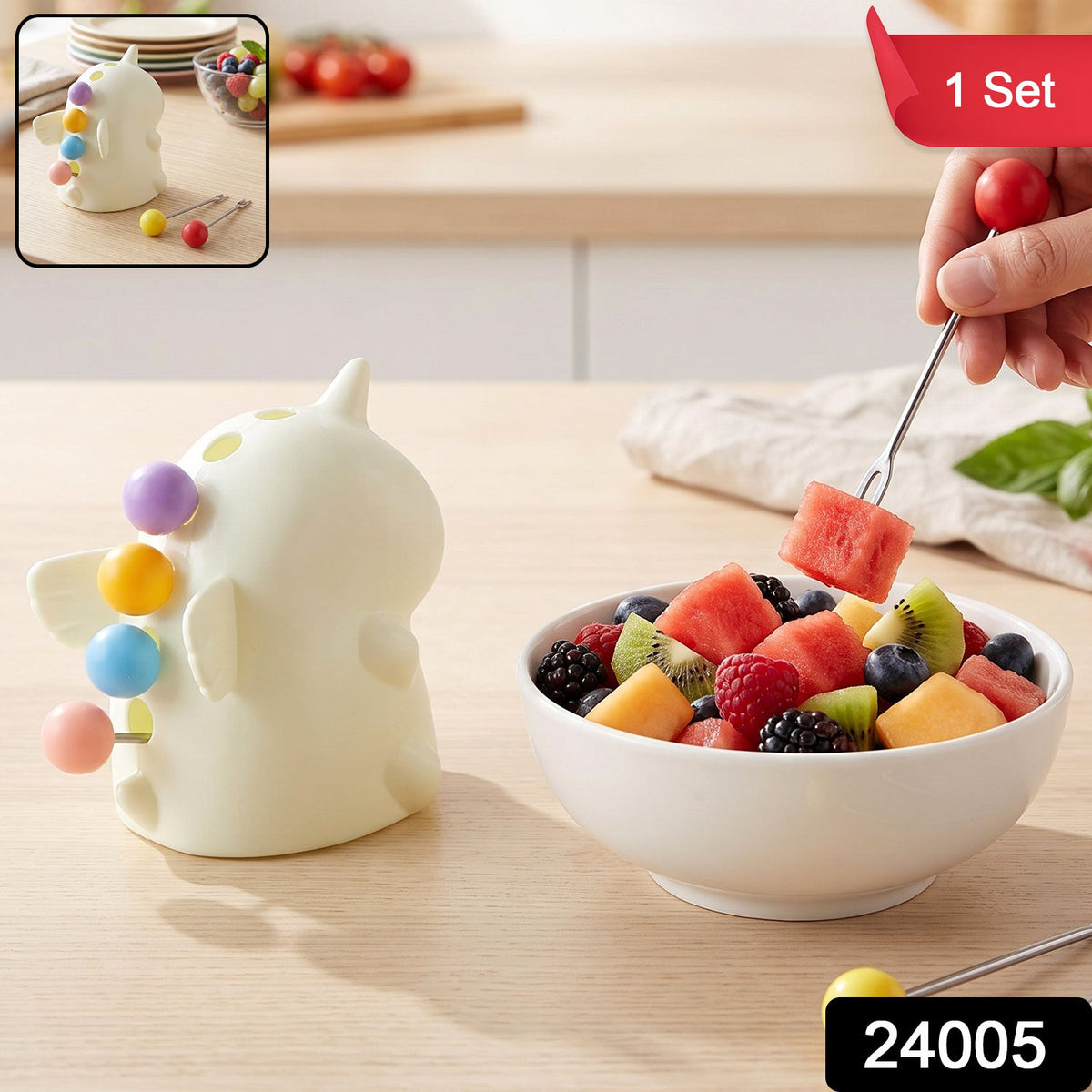 A hand uses a red-tipped fruit fork to pick up watermelon from a white bowl of mixed fruit next to a unicorn stand. – view 2