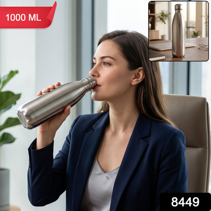 A woman in a navy blazer drinks from a silver stainless steel water bottle, with 1000 ML and 8449 labels.