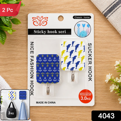 Retail packaging for two patterned adhesive hooks, featuring blue dolphins and yellow anchors, with a small inset showing