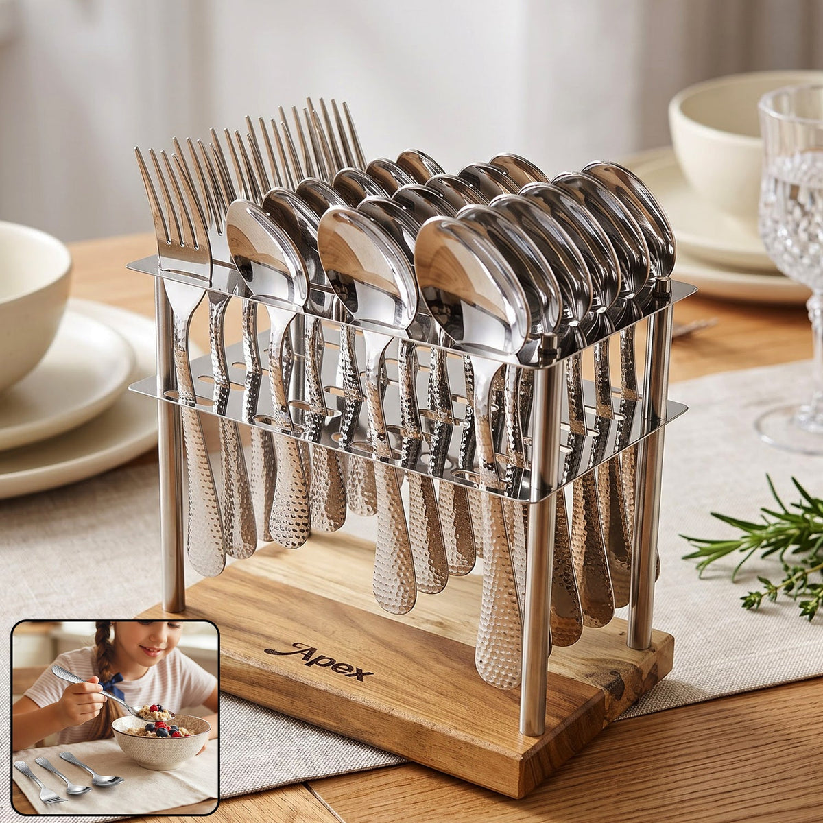 A 24-piece hammered stainless steel cutlery set with a wooden stand on a dining table. A small inset shows a girl eating