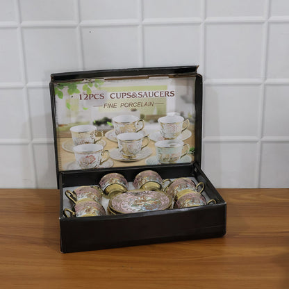 A black box containing six pink and gold floral porcelain teacups and saucers, with an image of more sets on the lid.