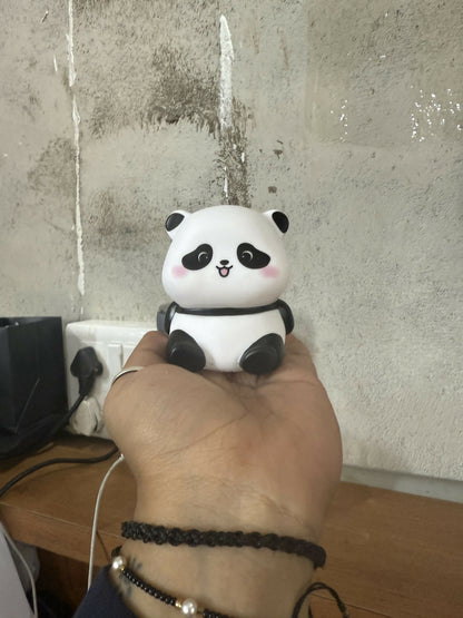 Side view of panda LED night lamp softly glowing in a kids' room
